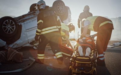 On the Car Crash Traffic Accident Scene: Rescue Team of Firefighters Pull Female Victim out of Rollover Vehicle, They Use Stretchers Carefully, Hand Her Over to Paramedics who Perform First Aid